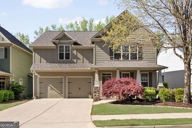 craftsman inspired home featuring board and batten siding, driveway, an attached garage, and a shingled roof
