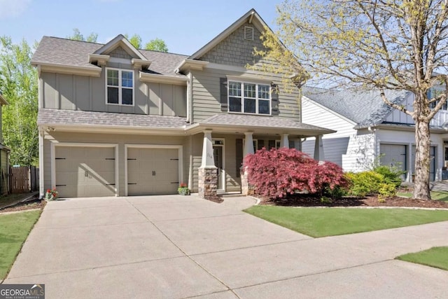 craftsman house with board and batten siding, concrete driveway, covered porch, an attached garage, and roof with shingles