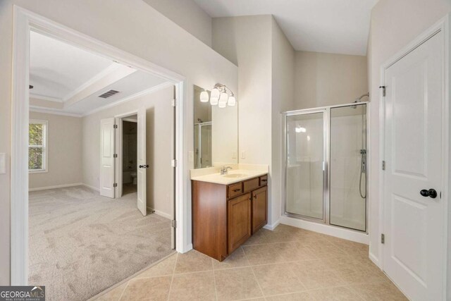 bathroom with a stall shower, ornamental molding, vanity, baseboards, and tile patterned flooring