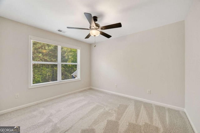 unfurnished room with carpet, a ceiling fan, and baseboards
