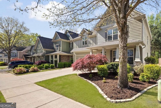 craftsman-style house featuring driveway, board and batten siding, a residential view, a front yard, and a garage