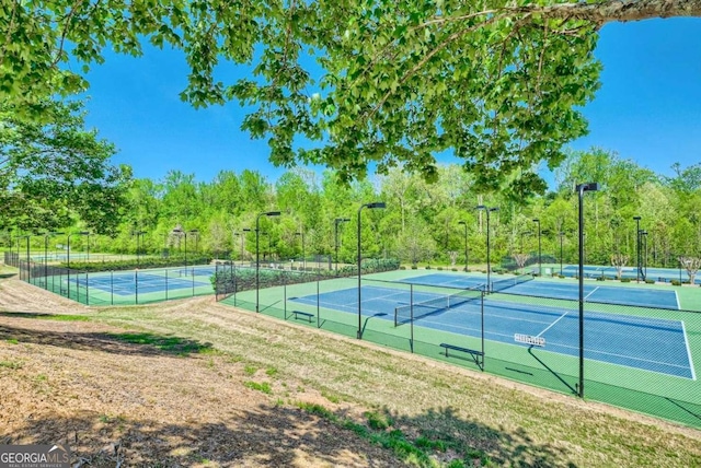 view of tennis court with fence
