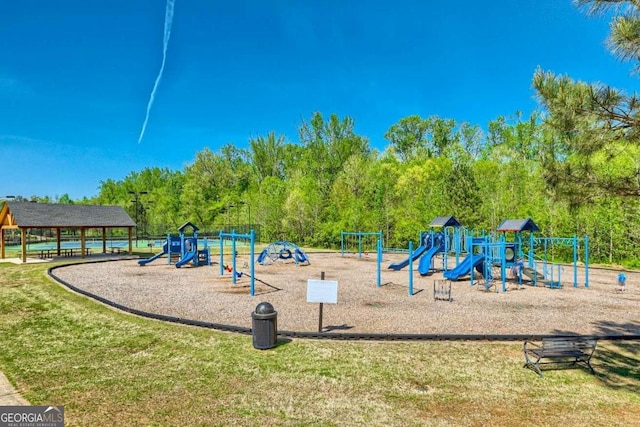 community jungle gym featuring a lawn
