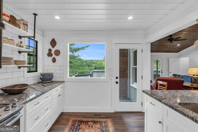 kitchen featuring dark wood-type flooring, dark stone counters, white cabinetry, open shelves, and recessed lighting