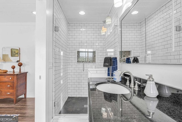 full bath with recessed lighting, a sink, a shower stall, and wood finished floors
