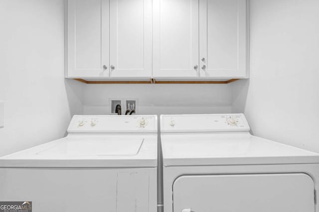 laundry area featuring washer and dryer and cabinet space