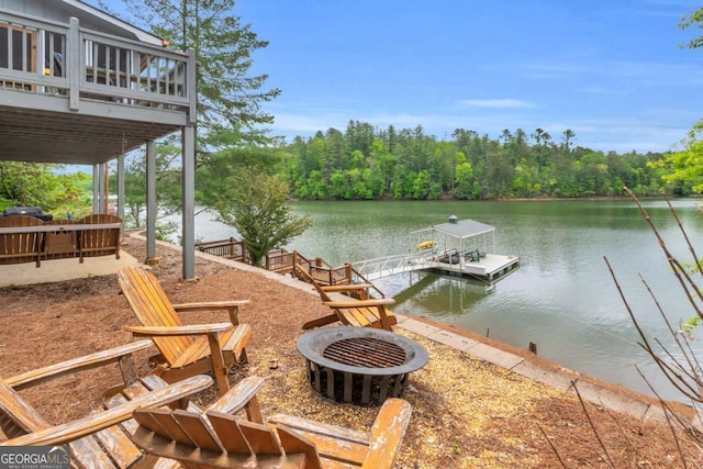dock featuring a fire pit and a water view