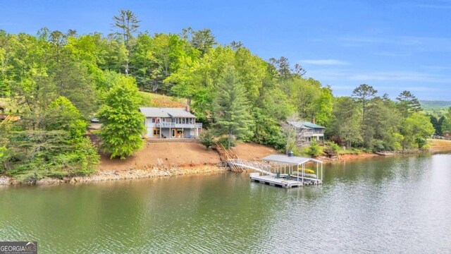 dock featuring a water view and a view of trees