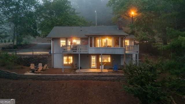 back of property with a patio area and a chimney