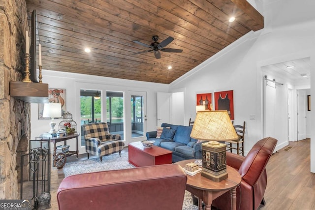living room featuring wooden ceiling, wood finished floors, lofted ceiling, ceiling fan, and a barn door
