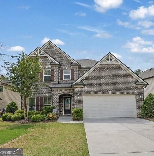 4050 Pleasant Woods Dr, Cumming, GA 30028 - view of front of property featuring brick siding, driveway, a garage, and a front yard