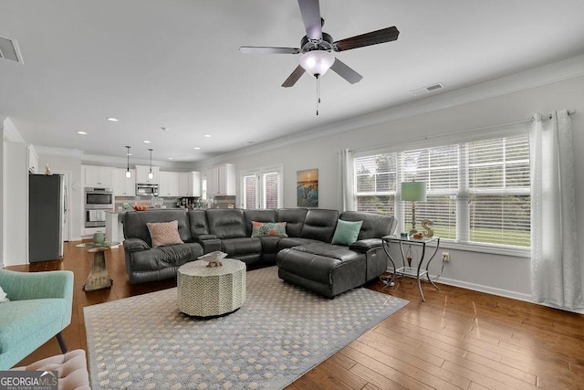4050 Pleasant Woods Dr, Cumming, GA 30028 - living area featuring ornamental molding, wood finished floors, ceiling fan, baseboards, and recessed lighting