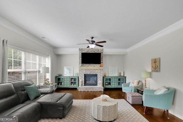 4050 Pleasant Woods Dr, Cumming, GA 30028 - living room featuring crown molding, dark wood finished floors, ceiling fan, and a fireplace