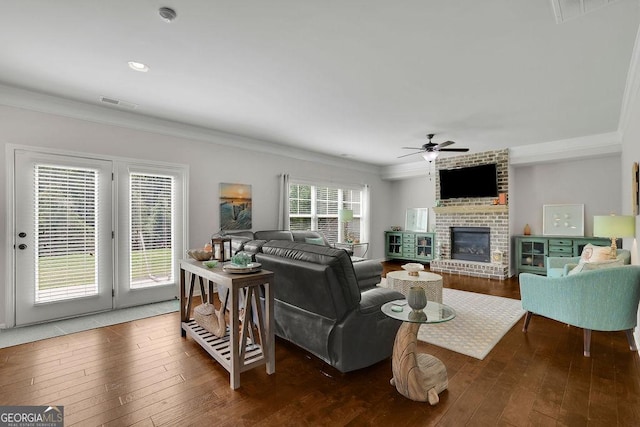 4050 Pleasant Woods Dr, Cumming, GA 30028 - living room featuring ceiling fan, ornamental molding, wood-type flooring, a brick fireplace, and recessed lighting