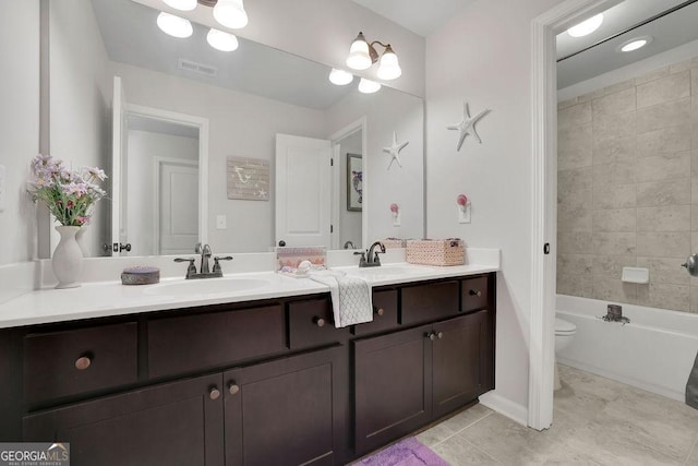 4050 Pleasant Woods Dr, Cumming, GA 30028 - bathroom featuring toilet, double vanity, tile patterned flooring, washtub / shower combination, and baseboards