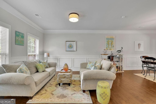 4050 Pleasant Woods Dr, Cumming, GA 30028 - living room with crown molding, dark wood-style flooring, a wainscoted wall, and a decorative wall