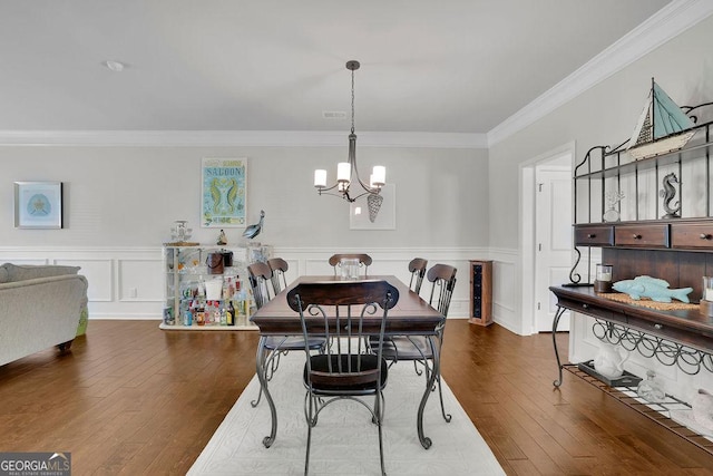 4050 Pleasant Woods Dr, Cumming, GA 30028 - dining room featuring a chandelier, crown molding, hardwood / wood-style floors, and wainscoting