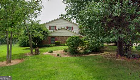 view of home's exterior with a lawn