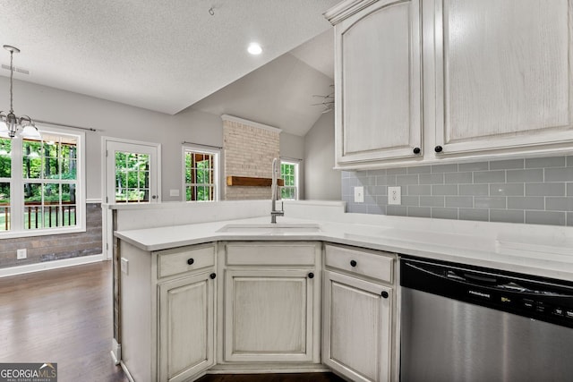84 Creekside Ct, Zebulon, GA 30295 - kitchen with stainless steel dishwasher, a peninsula, a sink, vaulted ceiling, and light countertops