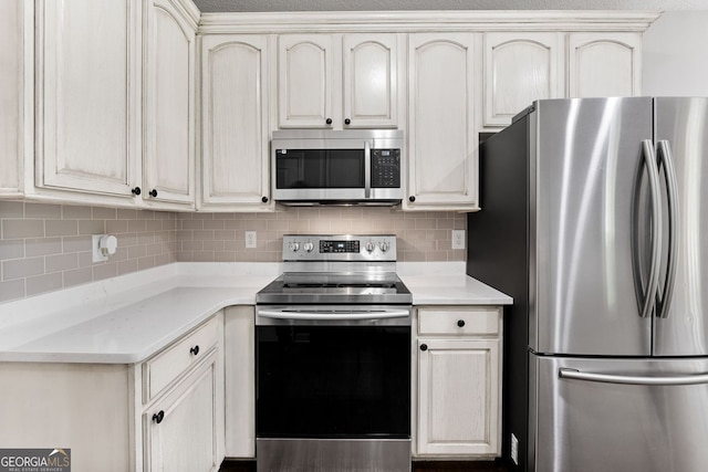 84 Creekside Ct, Zebulon, GA 30295 - kitchen with appliances with stainless steel finishes, cream cabinetry, and backsplash