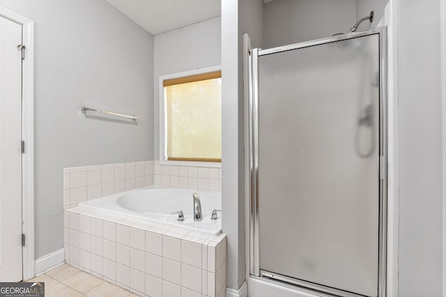 84 Creekside Ct, Zebulon, GA 30295 - bathroom featuring a stall shower, a bath, tile patterned flooring, baseboards, and a textured ceiling