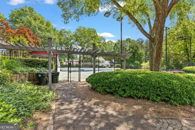 view of property's community with a gate and fence