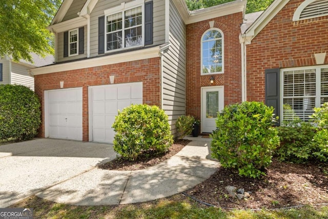 view of front of house featuring a garage, brick siding, and driveway