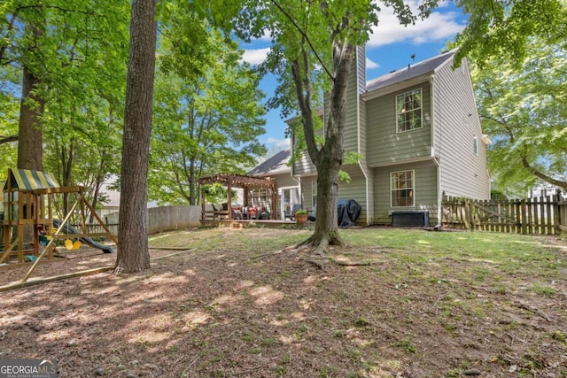 back of property with a pergola, a chimney, a fenced backyard, central AC unit, and a playground