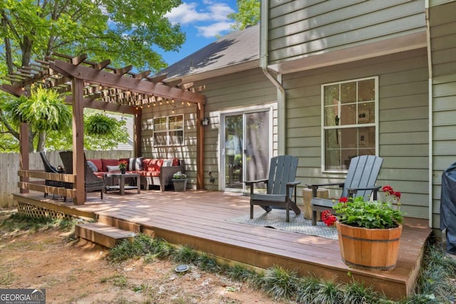 deck with an outdoor hangout area, a pergola, and fence
