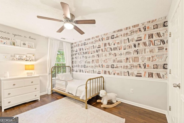 bedroom featuring baseboards, dark wood-style flooring, and ceiling fan