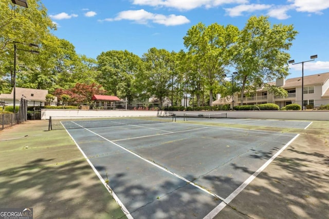 view of tennis court with fence