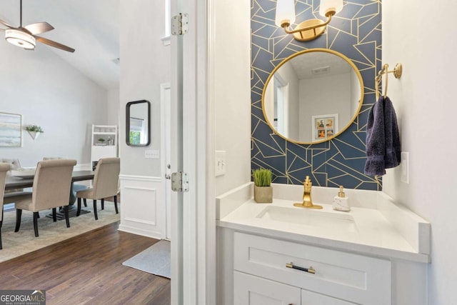 bathroom featuring wood finished floors, a ceiling fan, vaulted ceiling, and vanity
