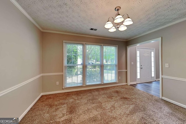 unfurnished dining area with a chandelier, carpet, ornamental molding, baseboards, and a textured ceiling