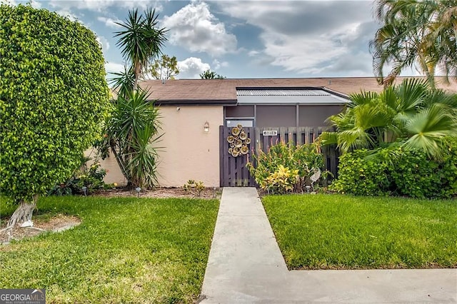 view of front of property with a front yard and stucco siding
