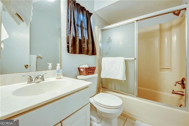 full bathroom featuring toilet, vanity, bath / shower combo with glass door, and tile patterned flooring