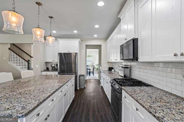 380 Longwood Pl, Dallas, GA 30132 - kitchen with black appliances, recessed lighting, white cabinetry, decorative backsplash, and a center island