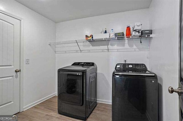 380 Longwood Pl, Dallas, GA 30132 - washroom featuring washing machine and dryer, light wood-style floors, and baseboards