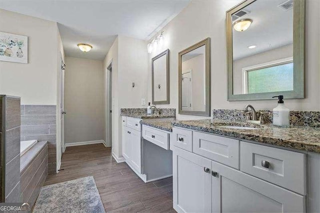 380 Longwood Pl, Dallas, GA 30132 - bathroom with vanity, wood finished floors, a bath, and baseboards