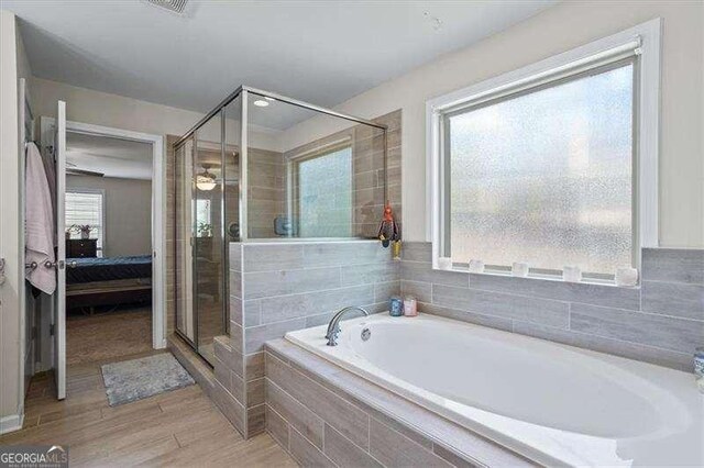 380 Longwood Pl, Dallas, GA 30132 - ensuite bathroom featuring a garden tub, a stall shower, and wood finished floors