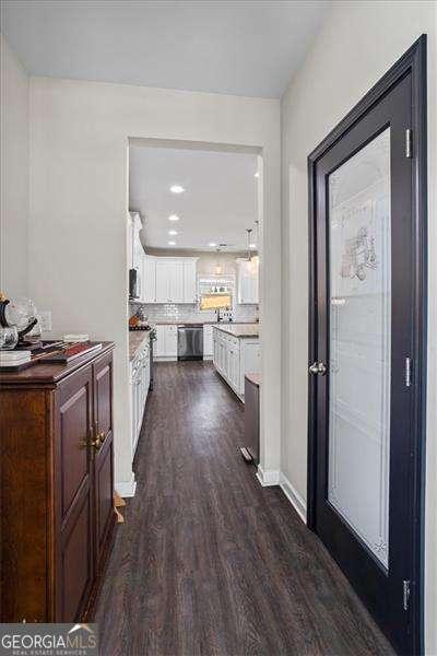 380 Longwood Pl, Dallas, GA 30132 - kitchen featuring dishwasher, dark wood-type flooring, white cabinets, light countertops, and baseboards