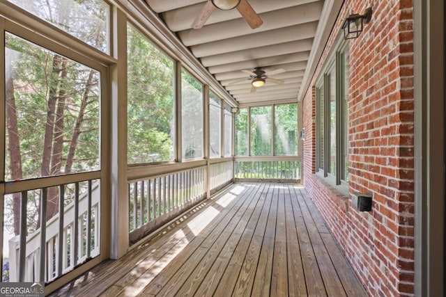 unfurnished sunroom with ceiling fan and plenty of natural light