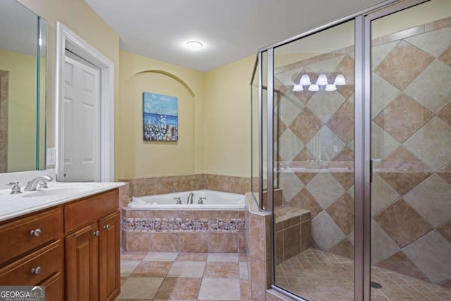 bathroom with a bath, vanity, and a shower stall