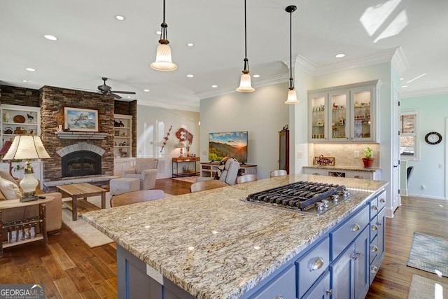 kitchen with stainless steel gas stovetop, blue cabinets, ceiling fan, dark wood-style floors, and recessed lighting