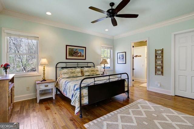 bedroom featuring multiple windows, baseboards, hardwood / wood-style floors, ornamental molding, and recessed lighting