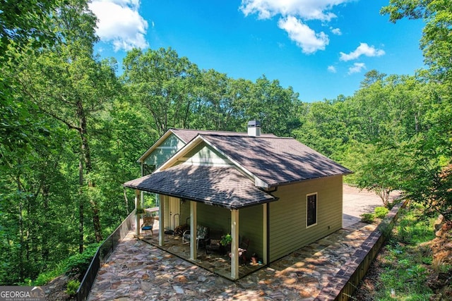 view of outdoor structure with a forest view