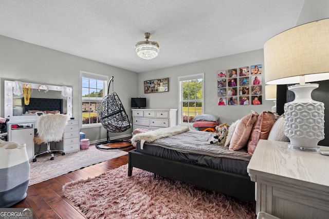 233 Clark Rd, Midville, GA 30441 - bedroom featuring multiple windows, hardwood / wood-style floors, and a textured ceiling