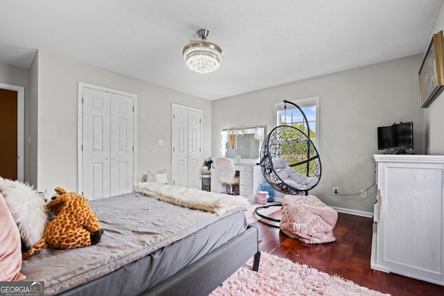 233 Clark Rd, Midville, GA 30441 - bedroom with dark wood-type flooring, baseboards, and a chandelier