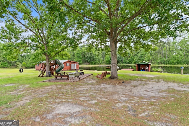 233 Clark Rd, Midville, GA 30441 - view of grassy yard with a storage shed, an outdoor structure, a water view, and view of wooded area