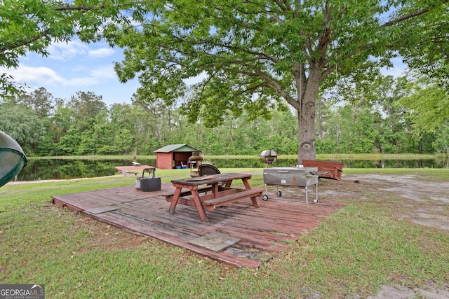 233 Clark Rd, Midville, GA 30441 - wooden terrace featuring a storage unit, an outdoor structure, and a water view