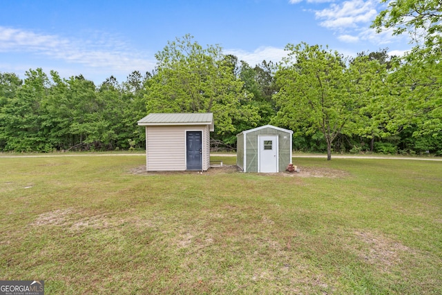 233 Clark Rd, Midville, GA 30441 - view of green lawn with a storage unit and an outdoor structure